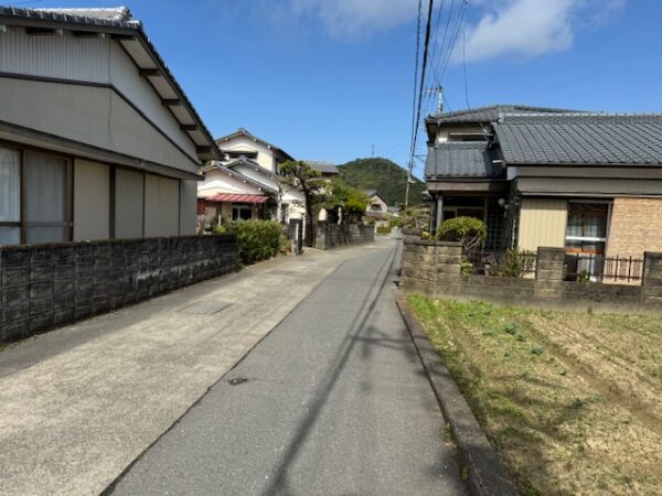 A paved road surface in a residential area.