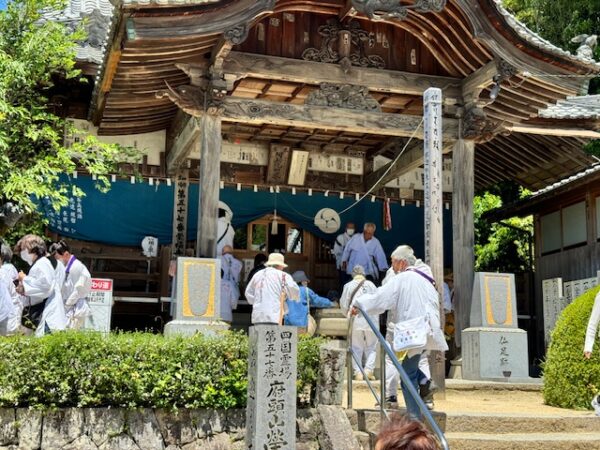 A pilgrim group praying at one of Imabari's city temples.