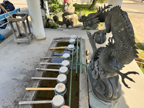 Fountain with a dragon spigot dispensing water treasures.