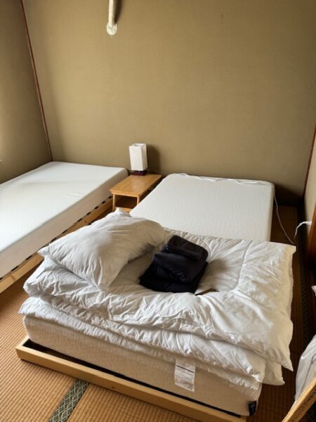 Futon bedding in dorm room in renovated guesthouse.