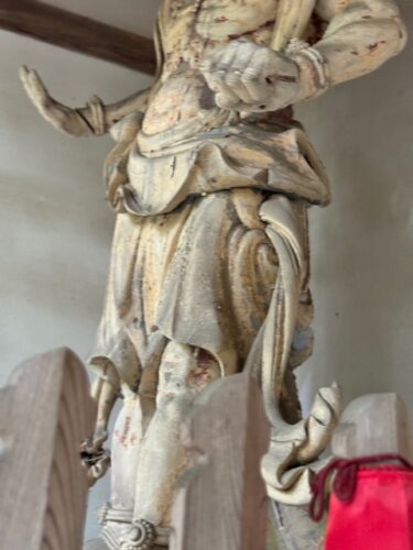 Close up of wood caved nio guardian at Iyadani-ji on Shikoku pilgrimage.