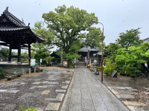 Rain on the promenade past the bell tower to the main temple.