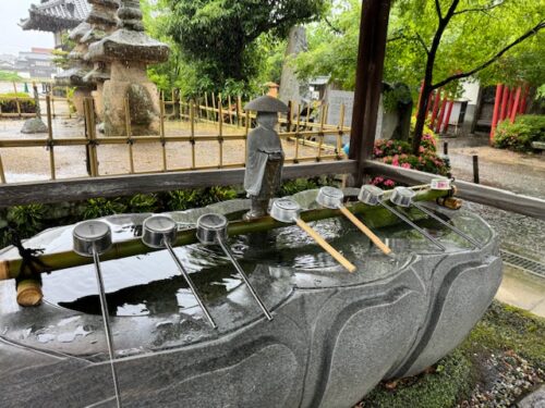 Rain falling on temple fountain.