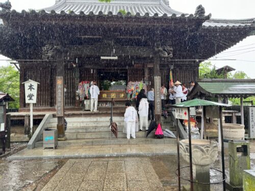 Visitors pray in the rain at main hall.