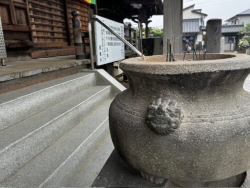 Incense urn cobines with rain to create a mellow mood at temple 87.