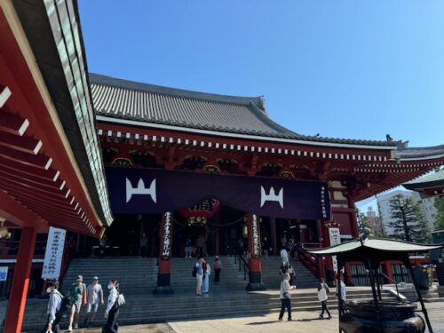 Main hall with purple banner at Senso-ji temple in Tokyo.