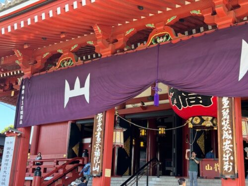 Front of Main hall with purple banner at Senso-ji temple in Tokyo.