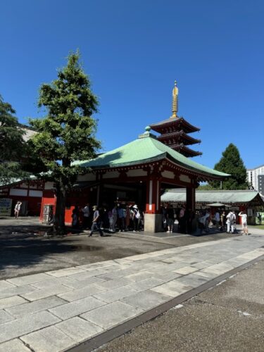 5-storied pagoda overlooking a building at Senso-ji temple in Tokyo.