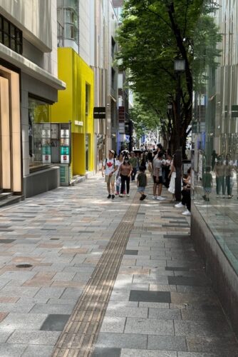 Shibuya ward in Tokyo people and buildings on a busy street.