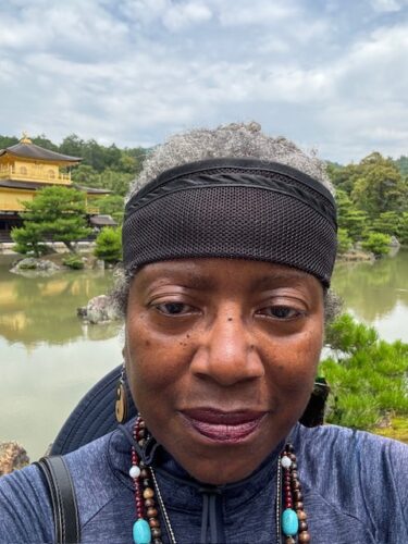 Ohenro in front of the Golden Pavilion in Kyoto, Japan.