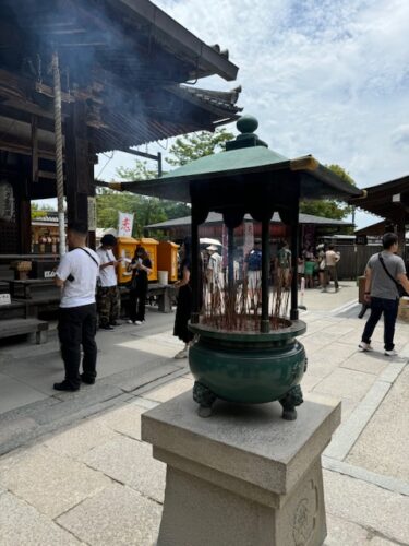 Urn in front of memorial hall at Kinkaku-ji temple in Osaka, Japan.