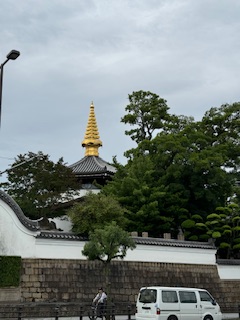 Golden spire of city street in Osaka city.