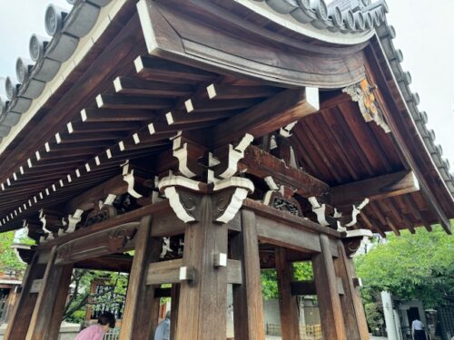 Wood structure over temple fountain.