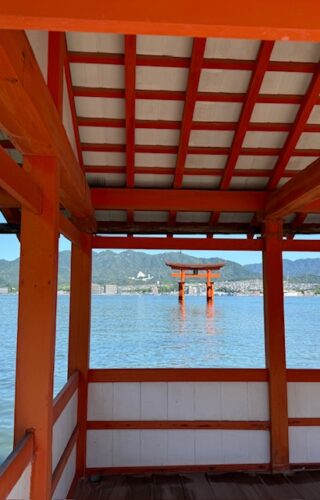 View of red torii from opening at Itsukushima Shrine at Miyajima.