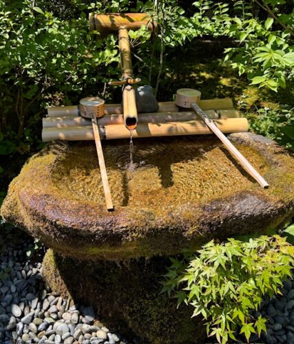 The traditional tsukubai style Japanese fountain made with stone and bamboo at Mitaki-dera.